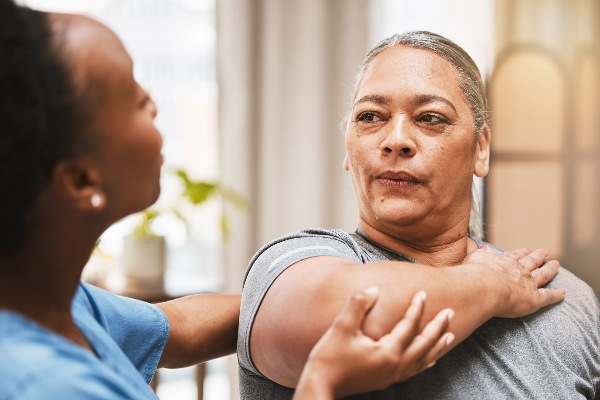 Physiotherapist consulting woman in physiotherapy for muscle, arthritis or stretching exercise, massage and breathing help. Physical therapy client, chiropractor and healthcare rehabilitation support