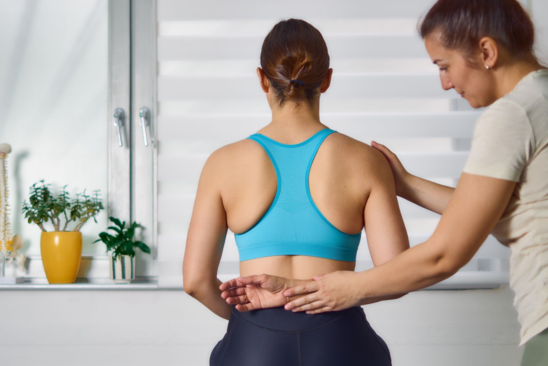 Young woman having chiropractic back adjustment.